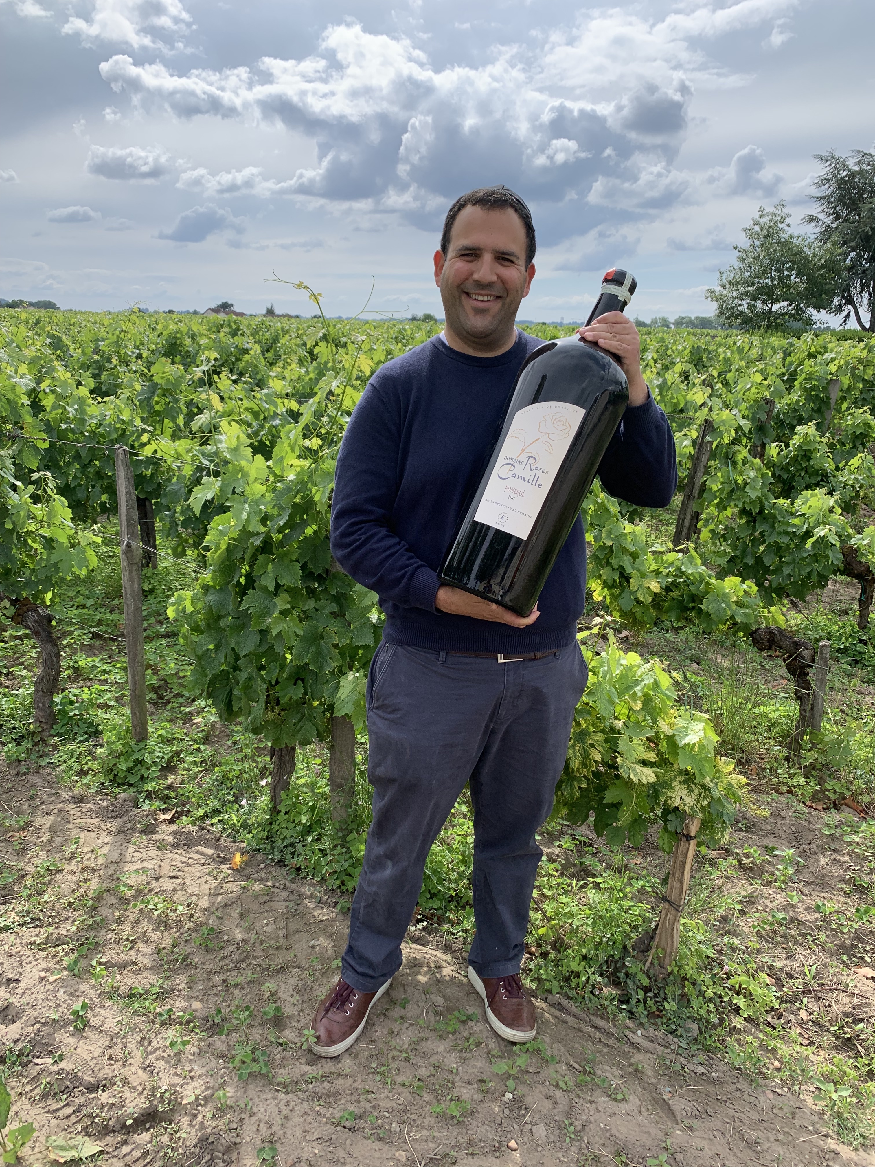 Photo of sommelier Andrew Breskin with giant bottle of Domaine Roses Camille.