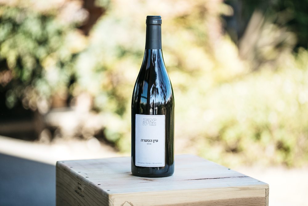 Solo photo of 2015 Ya’acov Oryah wine near vineyards.